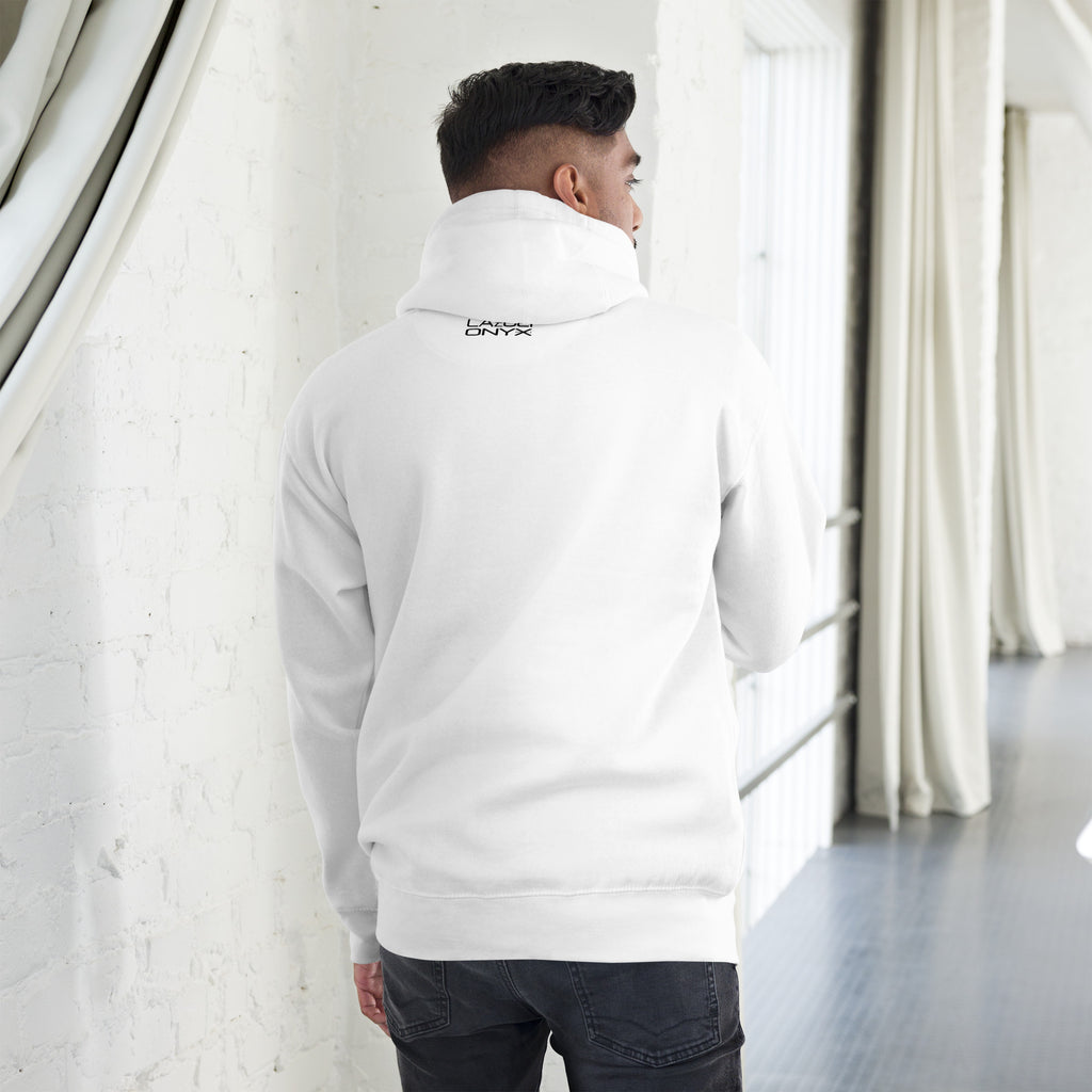Person wearing a white hoodie with a logo on the back, standing in a minimalistic room.