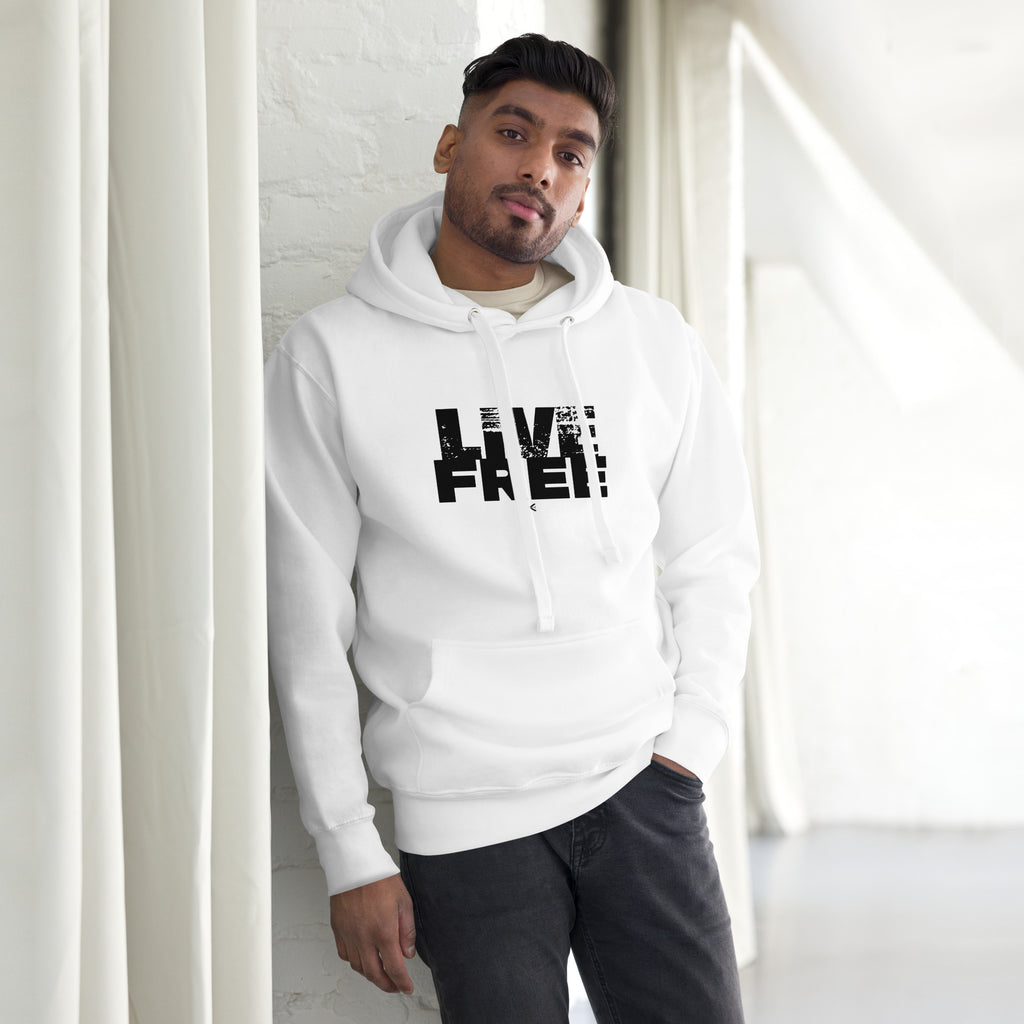Man wearing a white hoodie with 'LIVE FREE!' text in a modern indoor setting